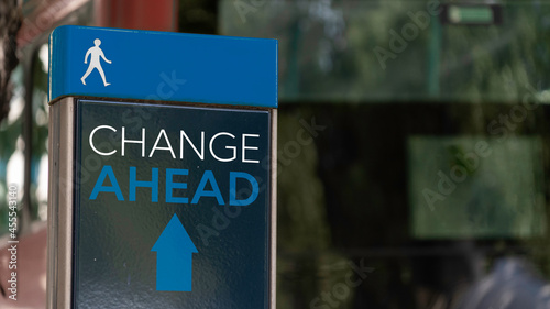 Photos Change Ahead with Arrow sign in a busy commuter city center
