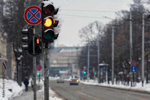 traffic light on a defocused city background on a winter day