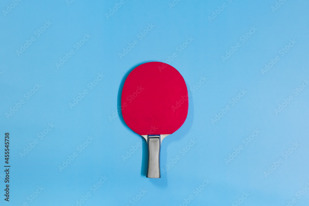 Pop art isolated image of red table tennis racket and blue background. The car can be used as an illustration or a sporting image. Pop art isolated image of red table tennis racket and blue background. The car can be used as an illustration or a sporting image.