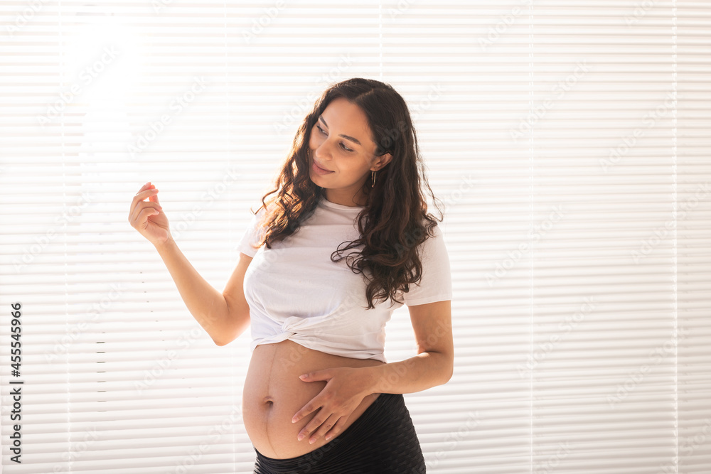 Pregnant woman touching her belly, copy space. Pregnancy and maternity leave Pregnant woman touching her belly, copy space. Pregnancy and maternity leave