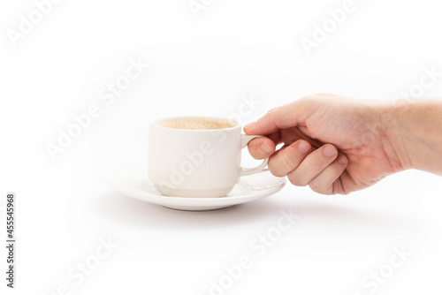 Hand grabbing a cup of coffee on white background