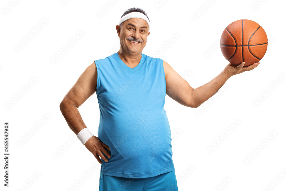 Smiling mature man in a blue jersey holding a basketball
