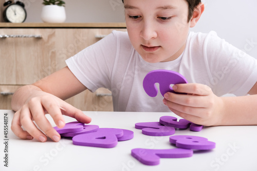 A boy learning math, count exercises at home