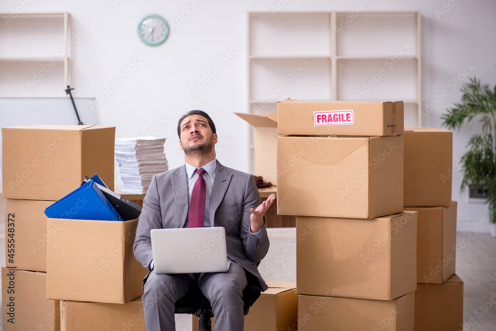 Young male employee in relocation concept Young male employee in relocation concept