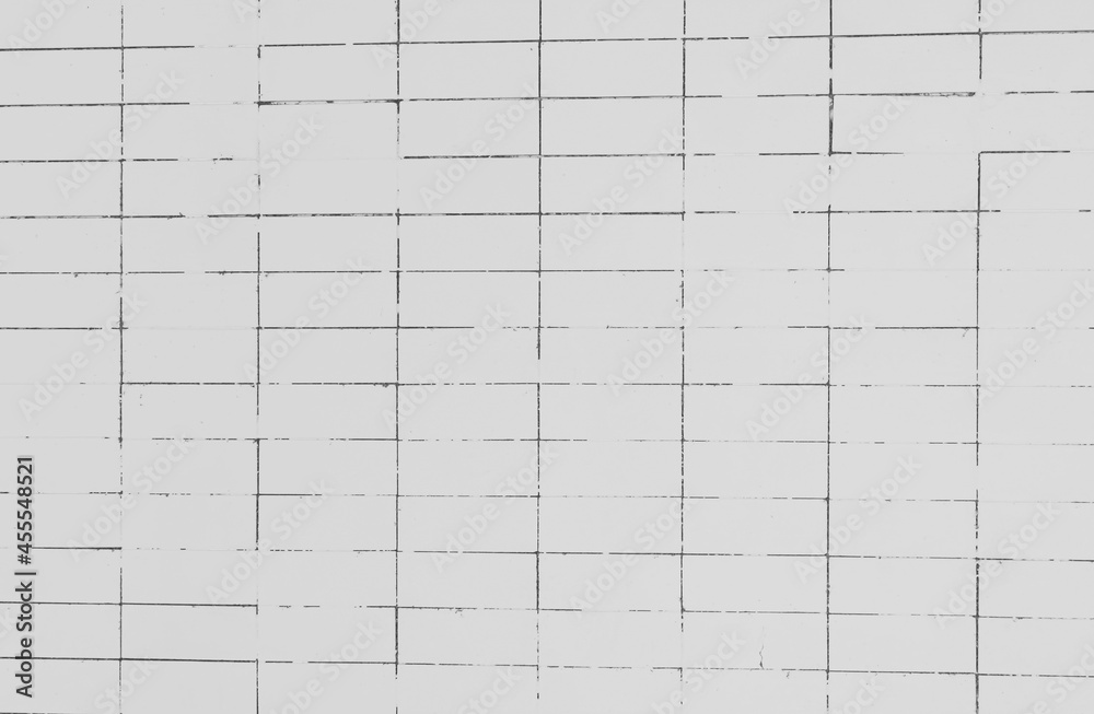 The inclined lines are not level along the lines of the marble wall tiles, White concrete wall