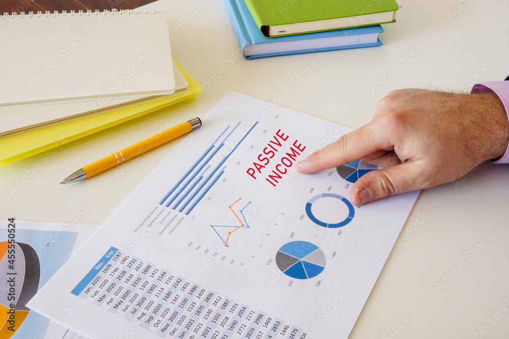 Financial concept meaning PASSIVE INCOME with sign on the sheet. Financial concept meaning PASSIVE INCOME with sign on the sheet.