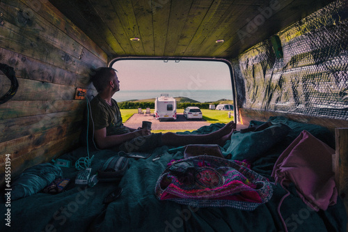 Fotografie, Obraz Caucasian guy from United Kingdom enjoying landscape from campervan