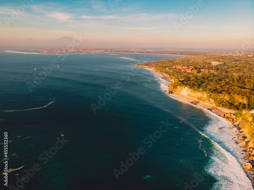 Aerial view with coastline and sea waves at sunset in Bali