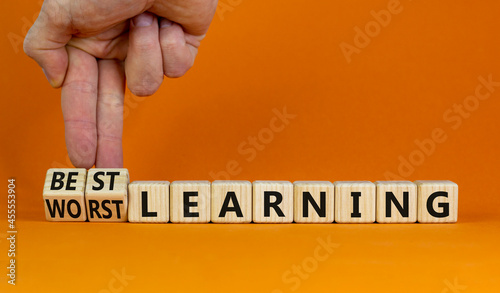 Best or worst learning symbol. Businessman turns cubes, changes words worst learning to best learning. Beautiful orange background. Business, education and best or worst learning concept. Copy space.