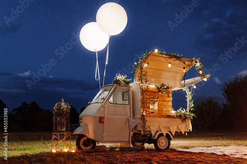 Mobile alcoholic bar on wheels car. Concept of holiday and outdoor recreation city. Cocktail reception and celebration photo