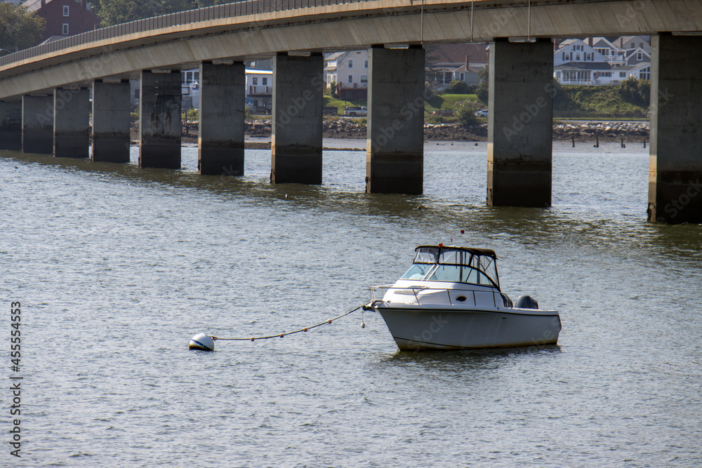 Fototapeta premium boat tied to buoy on the river close to bridge