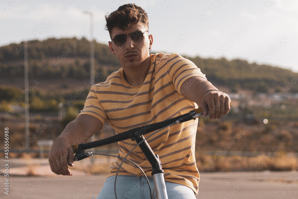 a latin boy riding a bmx bike.