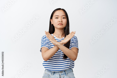 Принти на полотні Young asian woman make cross gesture, tell to stop, prohibit action, dislike smt