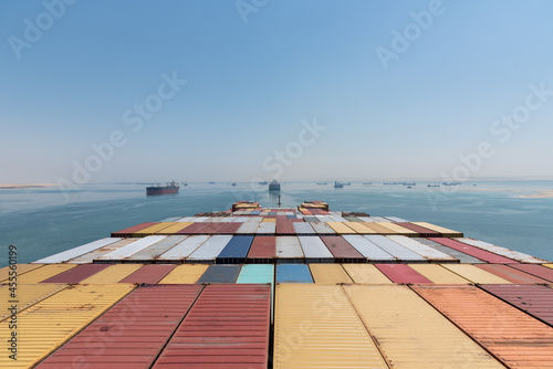 View on the containers loaded on deck of cargo ship. Vessel is transiting Suez Canal on her international trade route. 