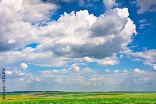 Field and blue sky with clouds