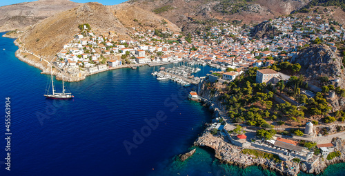 Fototapeta Naklejka Na Ścianę i Meble -  Aerial drone panoramic photo of the picturesque port and main village of Hydra (or Ydra) island at sunset. Hydra is a top tourist destination with neoclassic houses located in Saronic gulf, Greece.