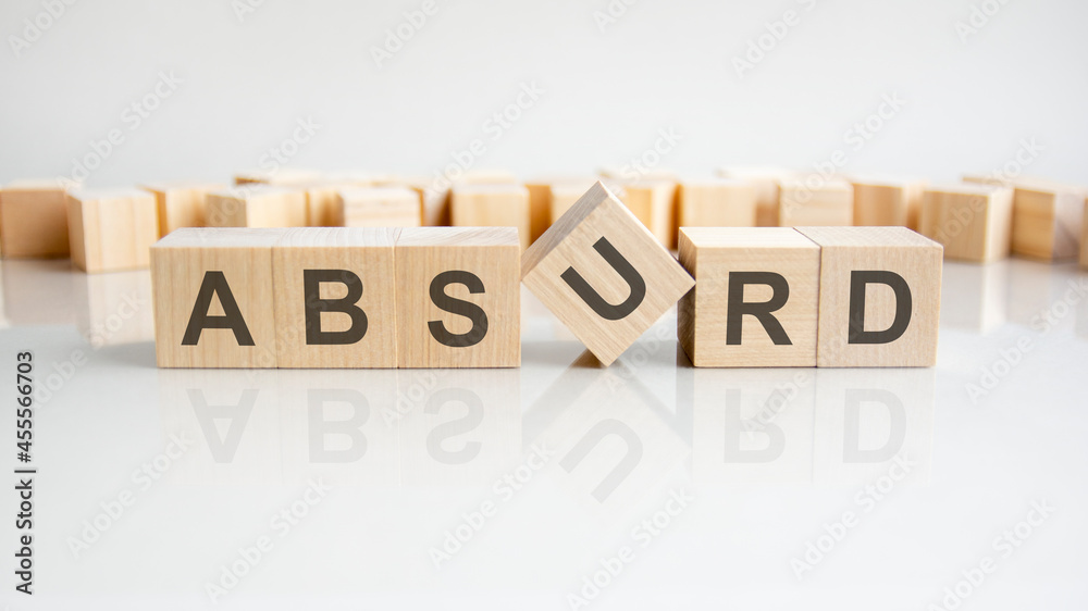absurd text on a wooden blocks, gray background. absurd text on a wooden blocks, gray background.