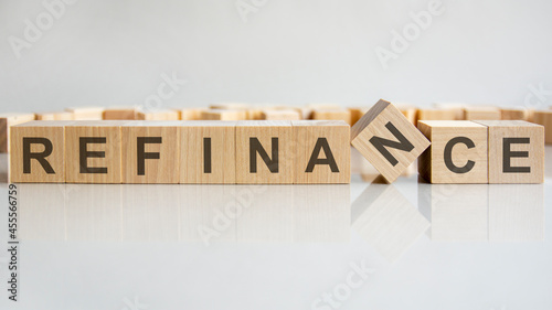 word refinance on wooden cubes, gray background photo