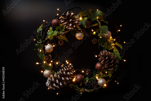 wreath with lights, balls and pine cones for new year eve