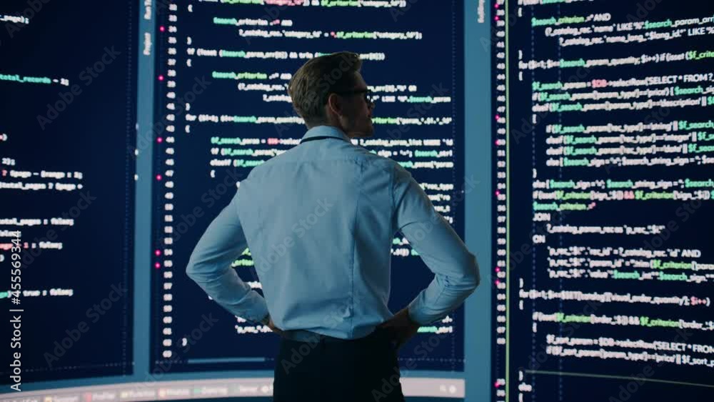 Innovative Startup: Brilliant Software Engineer Finding Solution, Doing Data Analysis with Big Screen Background. Programmer Developing Futuristic AI e-Commerce App. Dramatic Back View Innovative Startup: Brilliant Software Engineer Finding Solution, Doing Data Analysis with Big Screen Background. Programmer Developing Futuristic AI e-Commerce App. Dramatic Back View