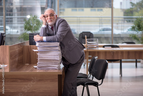 Old businessman employee and too much work in the office © Elnur