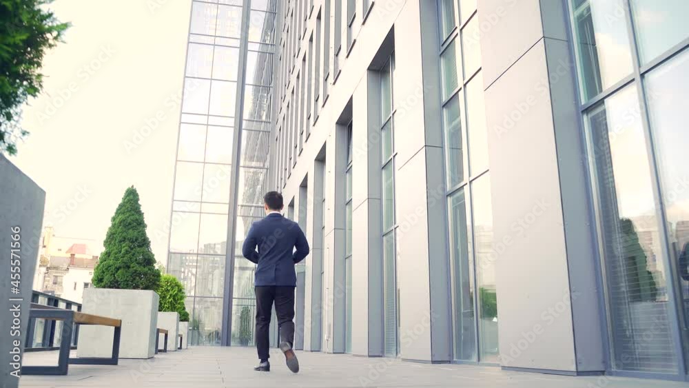 rear view of asian businessman go fast on uban background of modern office work in downtown. outside. Business man in formal suit walks behind rear view of asian businessman go fast on uban background of modern office work in downtown. outside. Business man in formal suit walks behind
