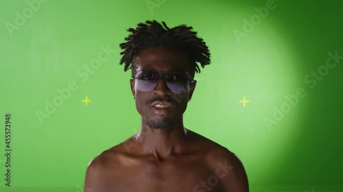 4K Portrait African black stylish man smiling with gold teeth. Grills , grillz. RAP style. Golden teeth. On green screen .  Few shots . Shot on RED EPIC Cinema Camera. photo