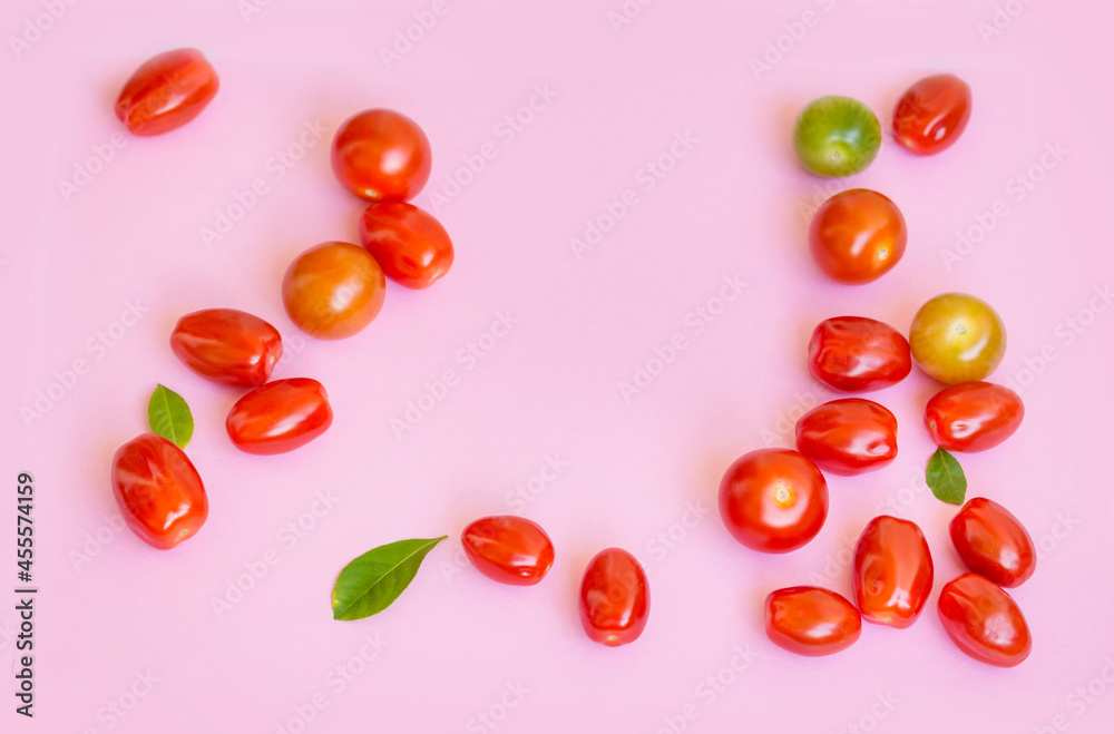 Organic Red Cherry Tomatoes on a Pink Background Organic Red Cherry Tomatoes on a Pink Background
