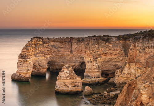 Natural arches at Marinha Beach at Twilight in Algarve Portugal