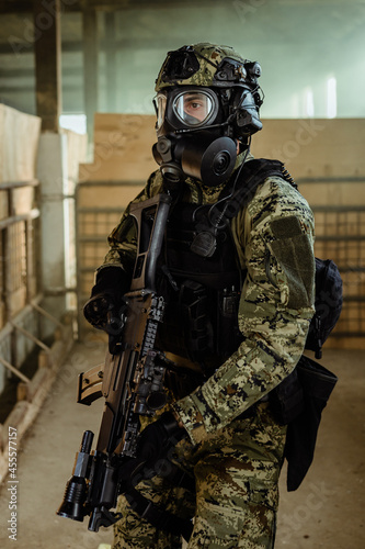 Armed man in military shield photo