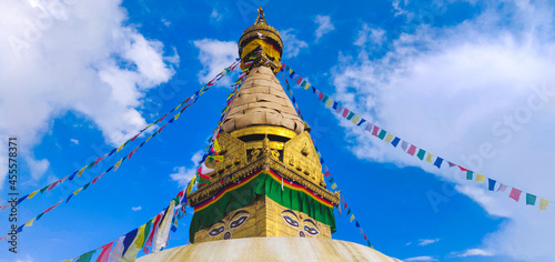 Close-up of ancient religious complex of Swayambhunath stupa with buntings in Kathmandu, Nepal