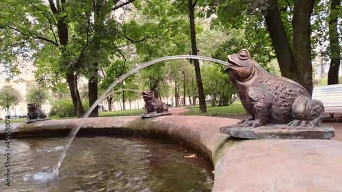 the part view of one of the fountains a frog blowing a water jet in the Nikolskiy garden near St. Nicholas Naval Cathedral in Saint-Petersburg , Russia