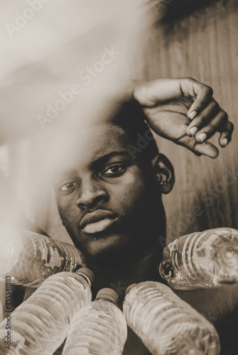 Grayscale Portrait of man with plastic bottle necklace photo