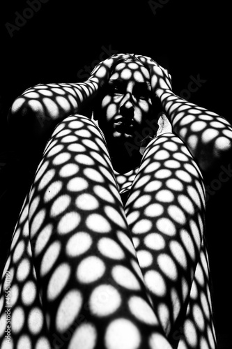Grayscale Portrait of woman in checkered shadow