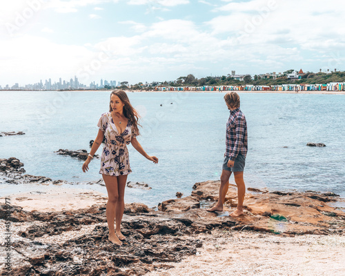 Man and woman standing on seashore