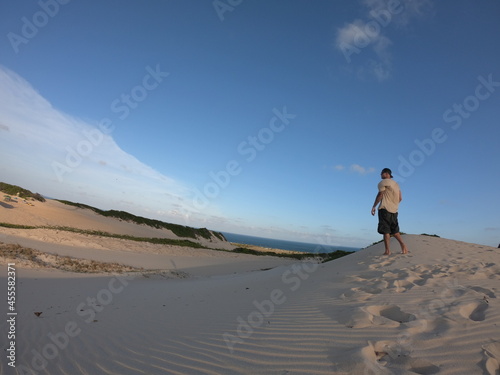 Man standing on sandy shore photo