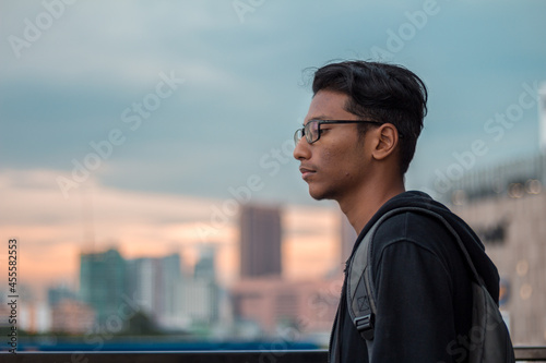 Man wearing eyeglasses and jacket near citi horizon photo