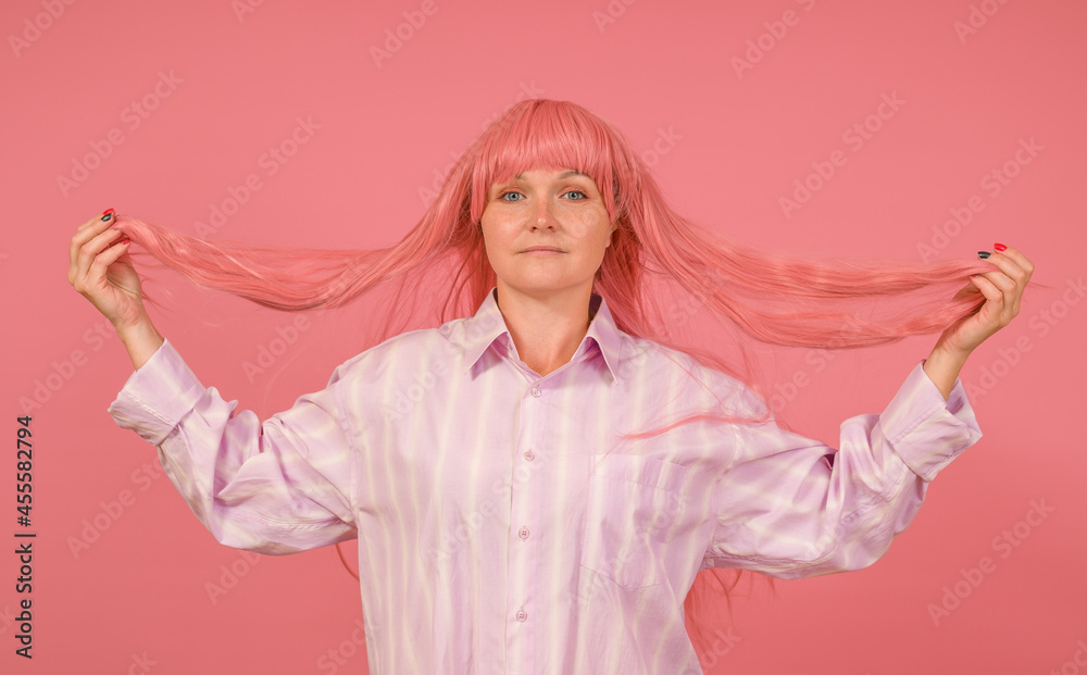woman in pink wig raised her hair with her hands