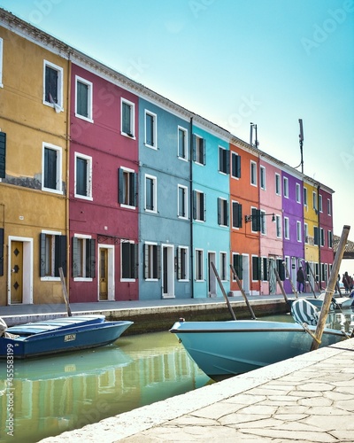 Multicolored building beside water canal and gondola photo