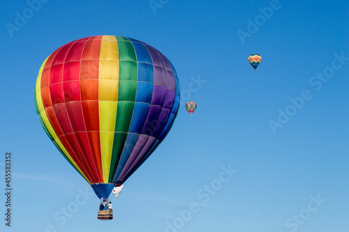 People in colorful hot air balloon in sky