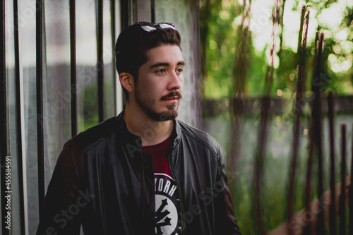 Portrait of man with sunglasses on his head standing outdoors