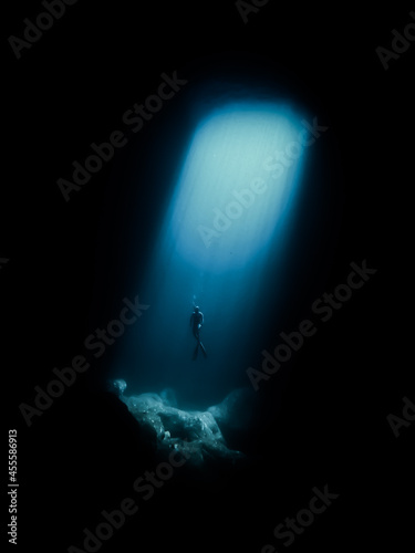 Underwater shot of Person diving in ocean depth