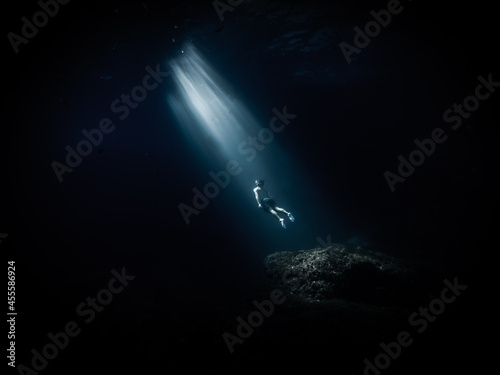 Wallpaper Mural Underwater shot of person diving in ocean depth Torontodigital.ca