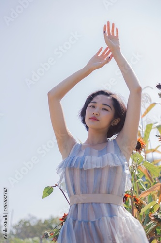 Woman in blue and oink plaid dress standing outdoor photo