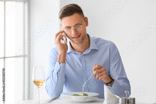 Young man talking by phone ...