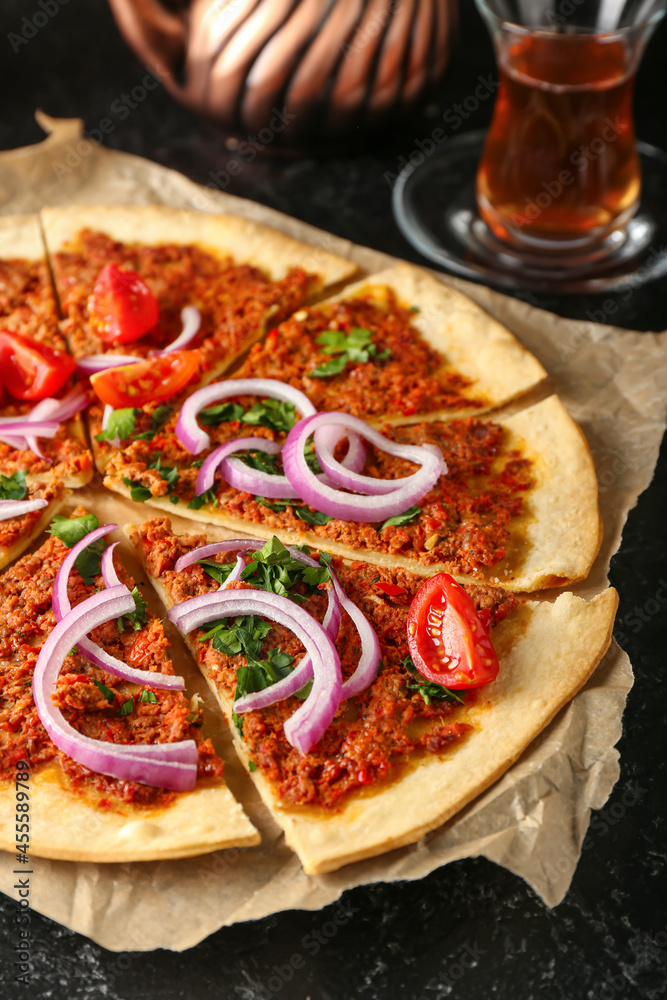 Delicious Turkish pizza on dark background Delicious Turkish pizza on dark background