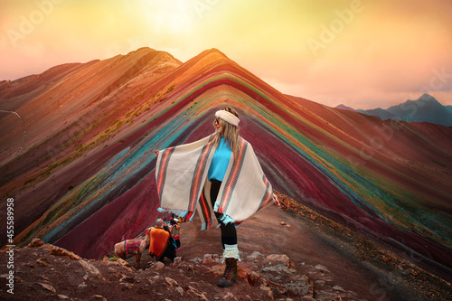 Woman standing in front of Vinicunca in Peru photo