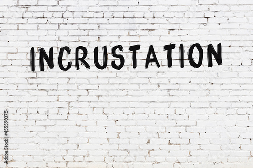 White wall with black paint inscription incrustation on it