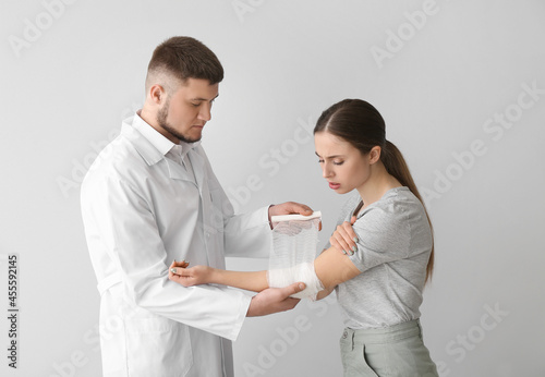 Doctor applying bandage ont...