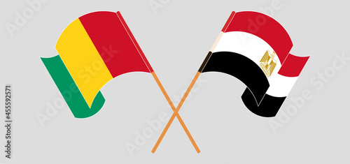 Crossed and waving flags of Guinea and Egypt